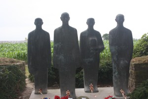 Emil Krieger's sculpture of four mourning figures watches over the last resting place of the fallen.